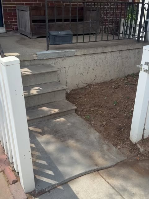 The front steps and yard after the ivy was cut back